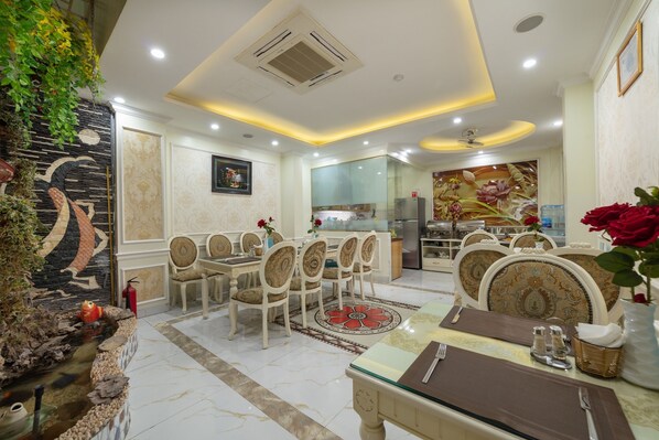 A dining area with a table set for four, surrounded by chairs with patterned upholstery.