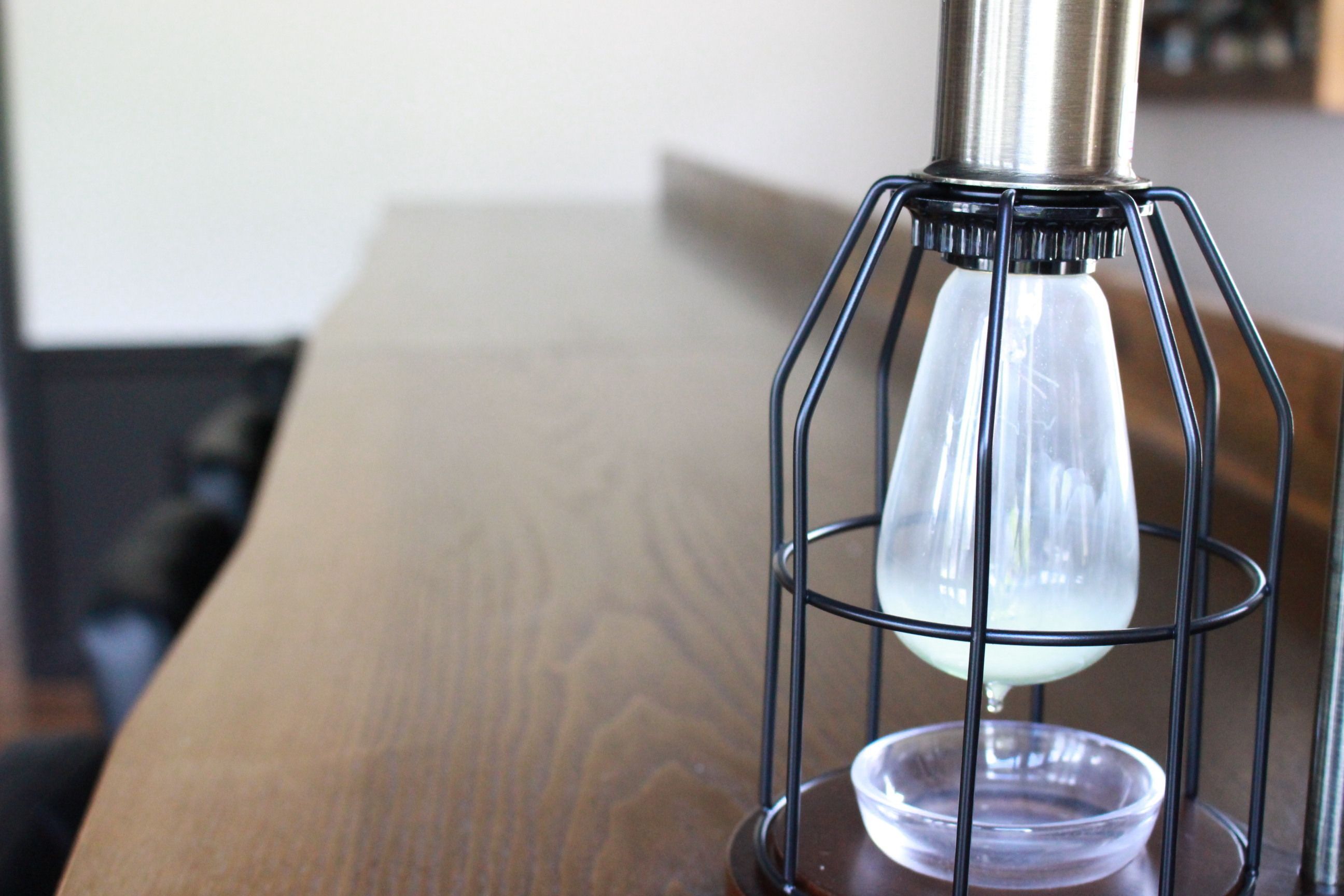 A table with a metal lamp fixture.