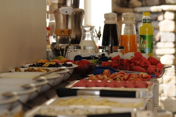 A buffet with various fruits, beverages, and condiments. - Tehran Boutique Hotel (Dogubayazit)