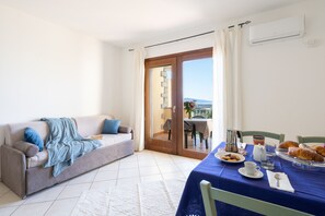 Classic Apartment, 1 Bedroom, Sea View | Living area | LCD TV - Residence Costa del Turchese by PendraHolidays (Badesi)