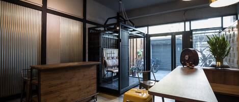 A modern kitchen with wooden countertops, a bar area, and a view through a glass door to a balcony.