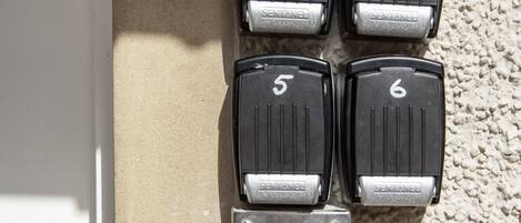 A wall-mounted keycard entry system with numbered keys and a keypad with multiple buttons labeled with room numbers and functions.