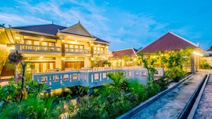 A two-story building with a balcony, surrounded by greenery and a small bridge. - Amour d'Angkor (Siem Reap)
