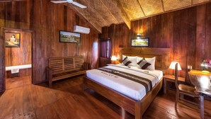 A wooden-themed room with a bed, a bench, a ceiling fan, and wall-mounted air conditioning. - Amour d'Angkor (Siem Reap)
