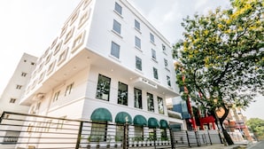 A modern white building with multiple windows and a gated entrance. - Octave Hotel Double Rd (Bengaluru)