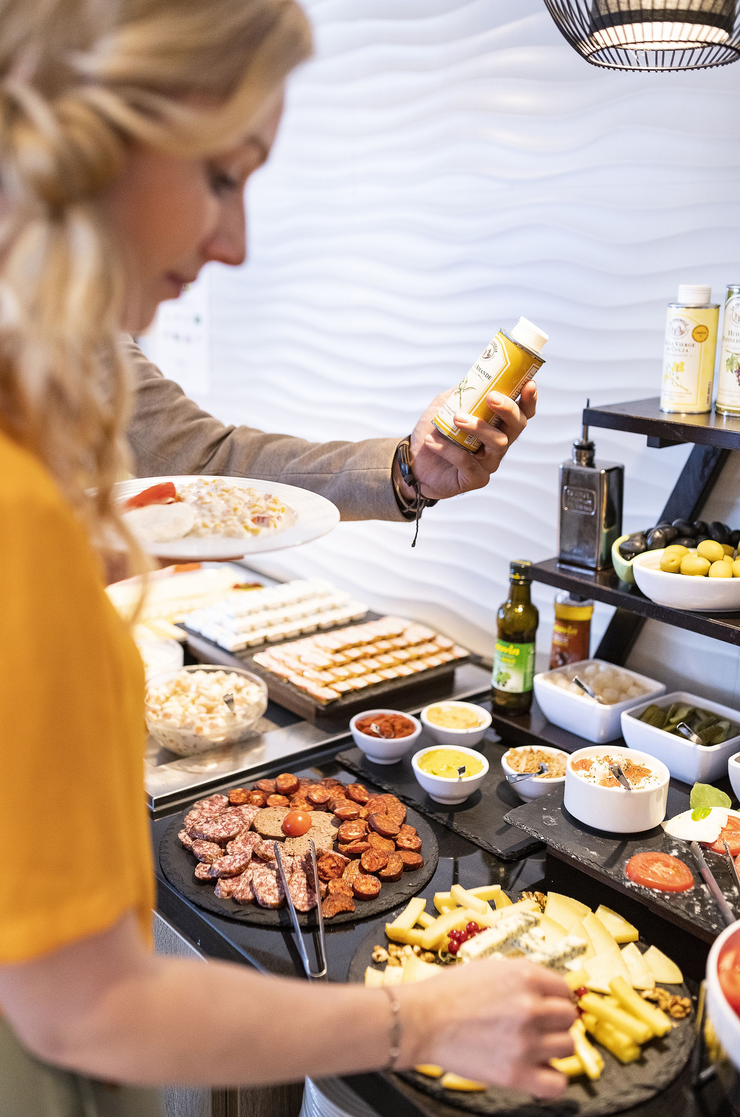 A buffet with various food items and condiments.