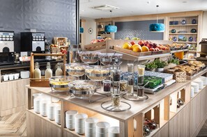 A breakfast buffet with various food items and beverages. - Three Corners Lifestyle Hotel (Budapest)