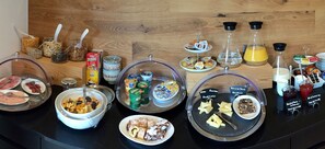 A buffet with various food items and condiments.