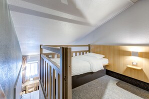 A compact bedroom with a bunk bed, a desk, and a small bedside table. - B&B HOTEL Orgeval (Orgeval)