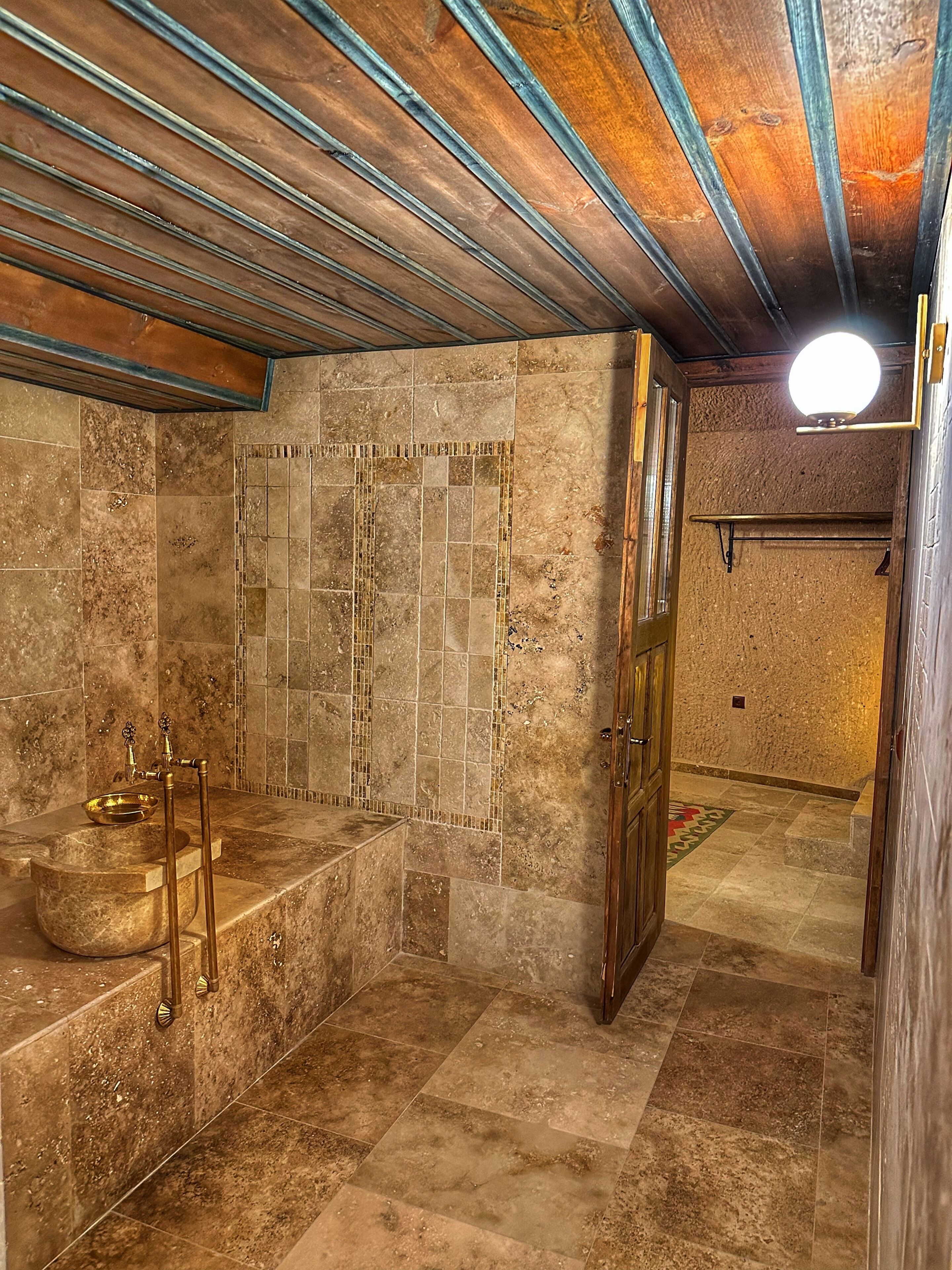 hammam cave suite | bathroom | shower, free toiletries, hair dryer, slippers