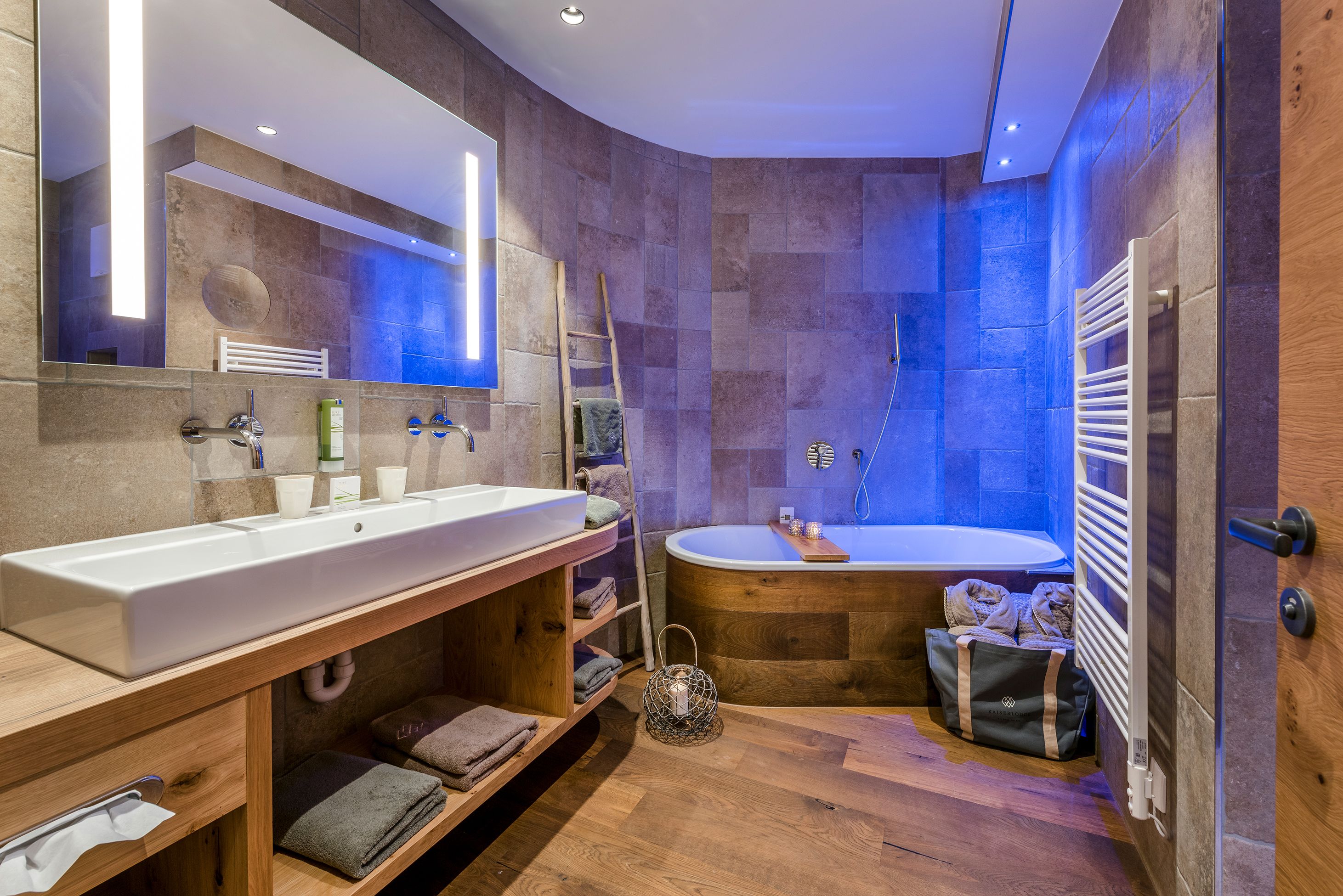 A modern bathroom with a large sink, a bathtub, and a shower.