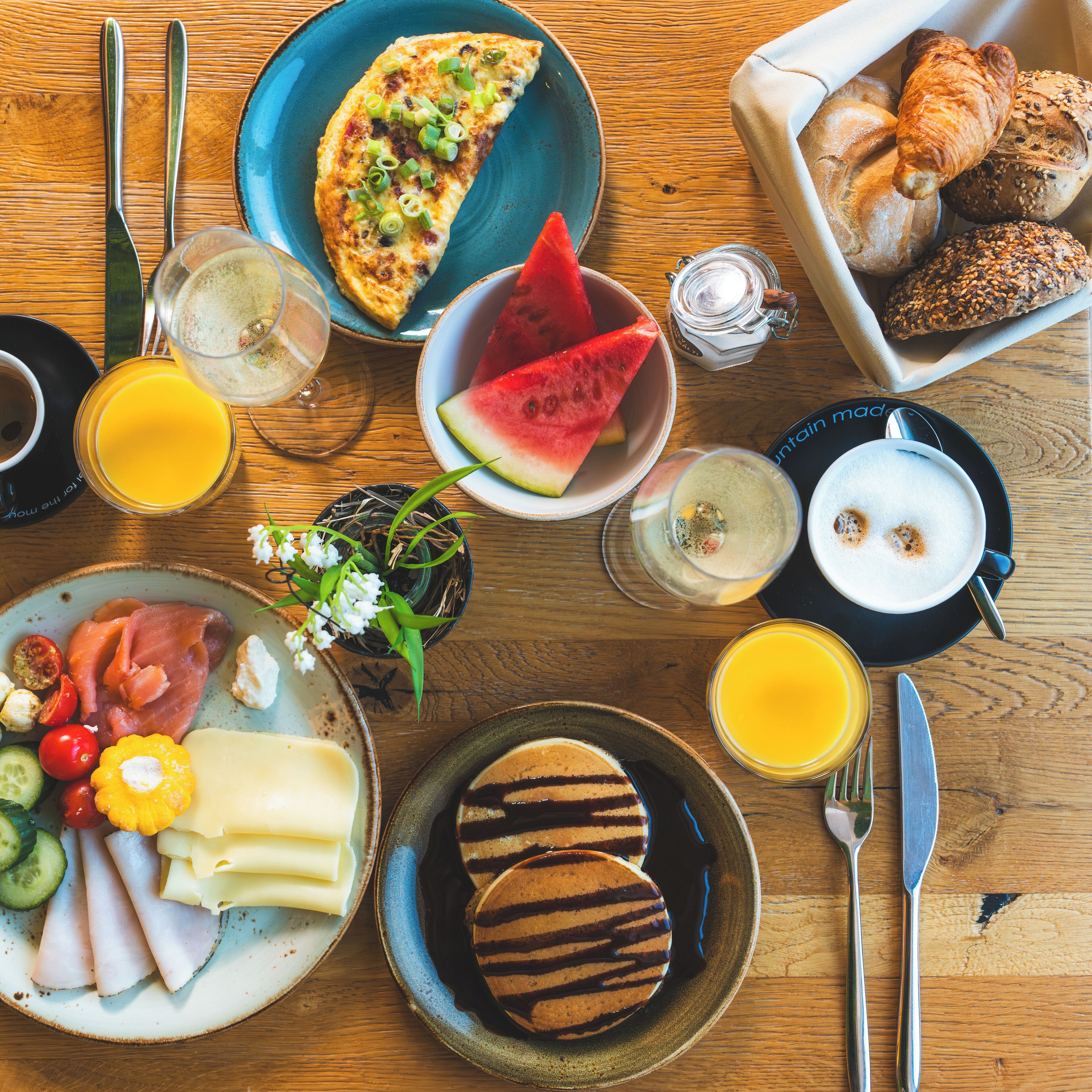 A breakfast buffet with various food items and beverages.