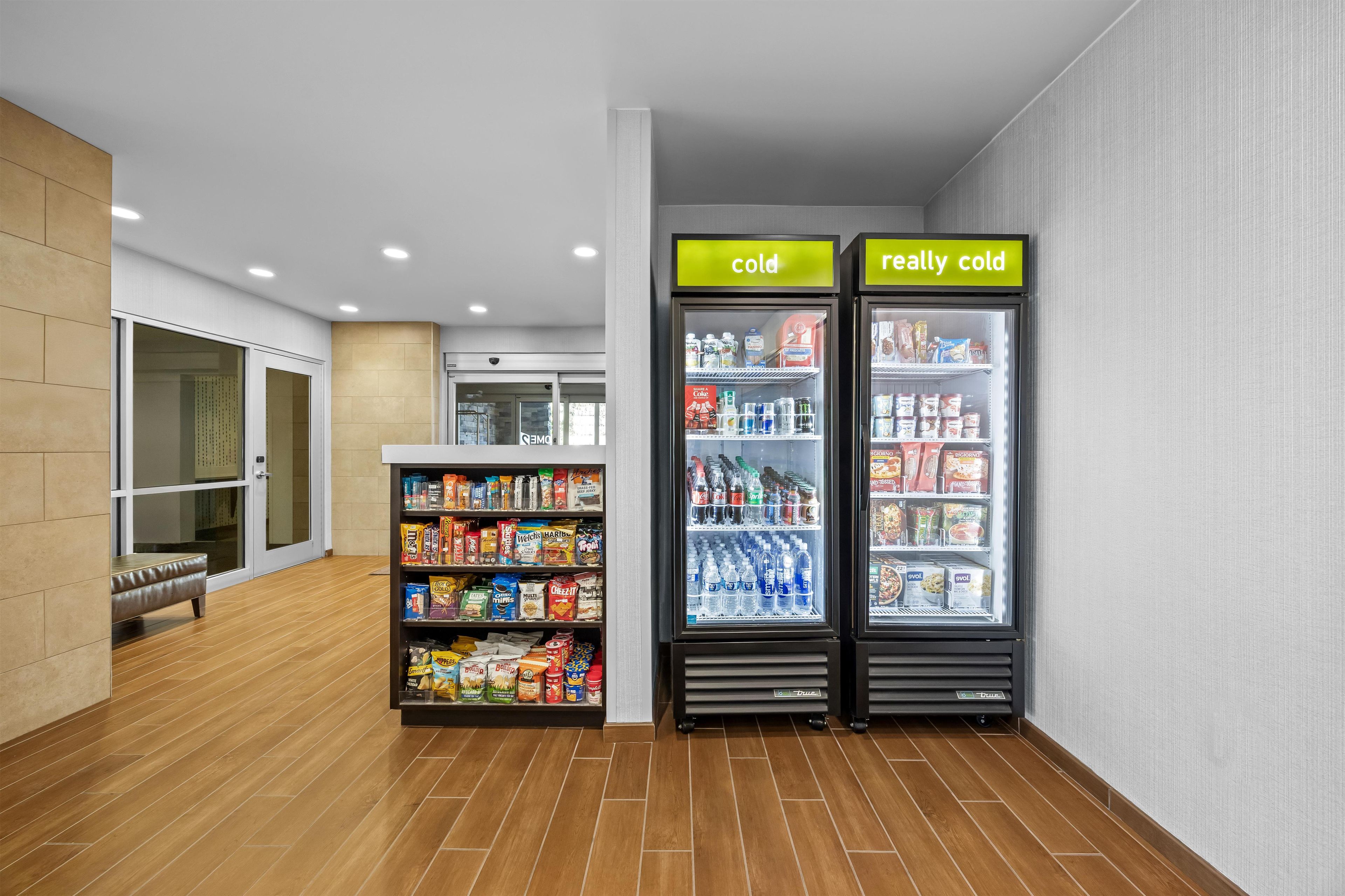 A vending area with two refrigerated units labeled 'cold' and 'really cold,' stocked with beverages and snacks.