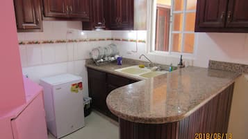 Full-size fridge, microwave, cookware/dishes/utensils