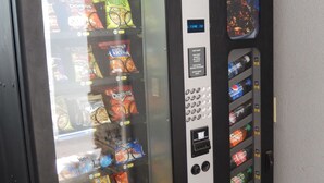 A vending machine with various snacks and drinks, including Doritos, Funyuns, and Pepsi. - Studio 6 Yukon, OK (Yukon)
