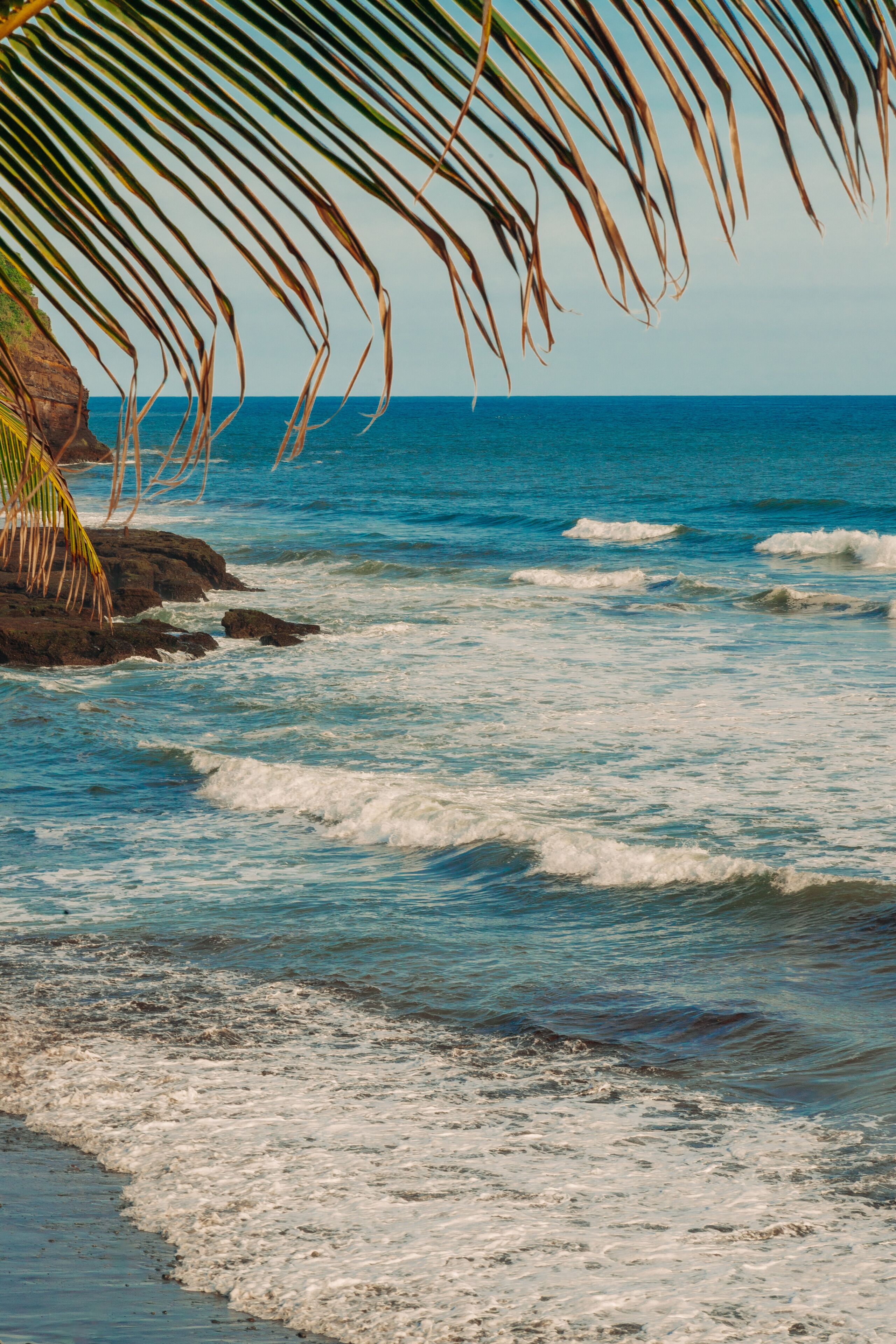 on the beach, black sand, beach towels, surfing