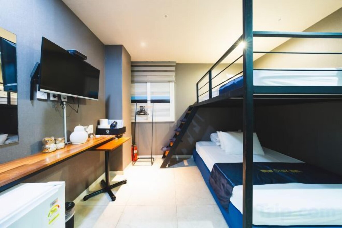 Premium bedding, desk, laptop workspace, blackout drapes