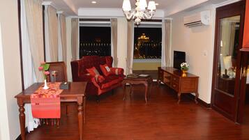 President View Suite | Living room | 24-inch LCD TV with cable channels, TV