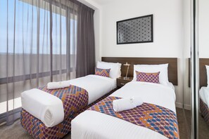 Premium bedding, desk, laptop workspace, blackout curtains