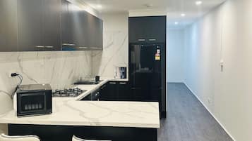 Premium bedding, desk, laptop workspace, blackout drapes