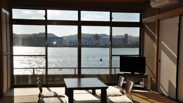 A room with tatami flooring, a low table, and a television. - Kahan no Yado Karatsu Castle (Karatsu)