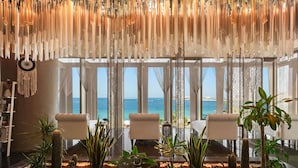 A room with a view of the sea, a hanging light fixture, and a cactus garden. - Rixos Premium Dubai JBR (Dubai)