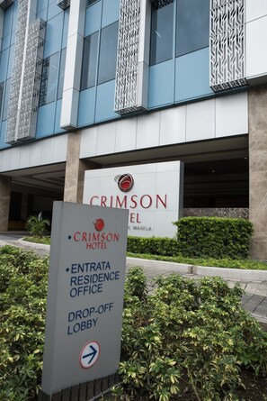 A sign for the Crimson Hotel in Manila, indicating the entrance, residence office, and drop-off lobby. - Titan Condo at Entrata Alabang (Muntinlupa)