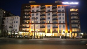 Un hotel de varios pisos con un cartel llamativo que dice "HOTEL AHSARAY".