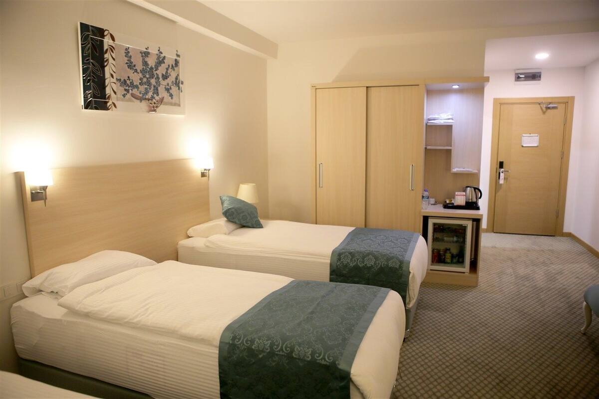 family triple room, city view | premium bedding, free minibar items, in-room safe, desk