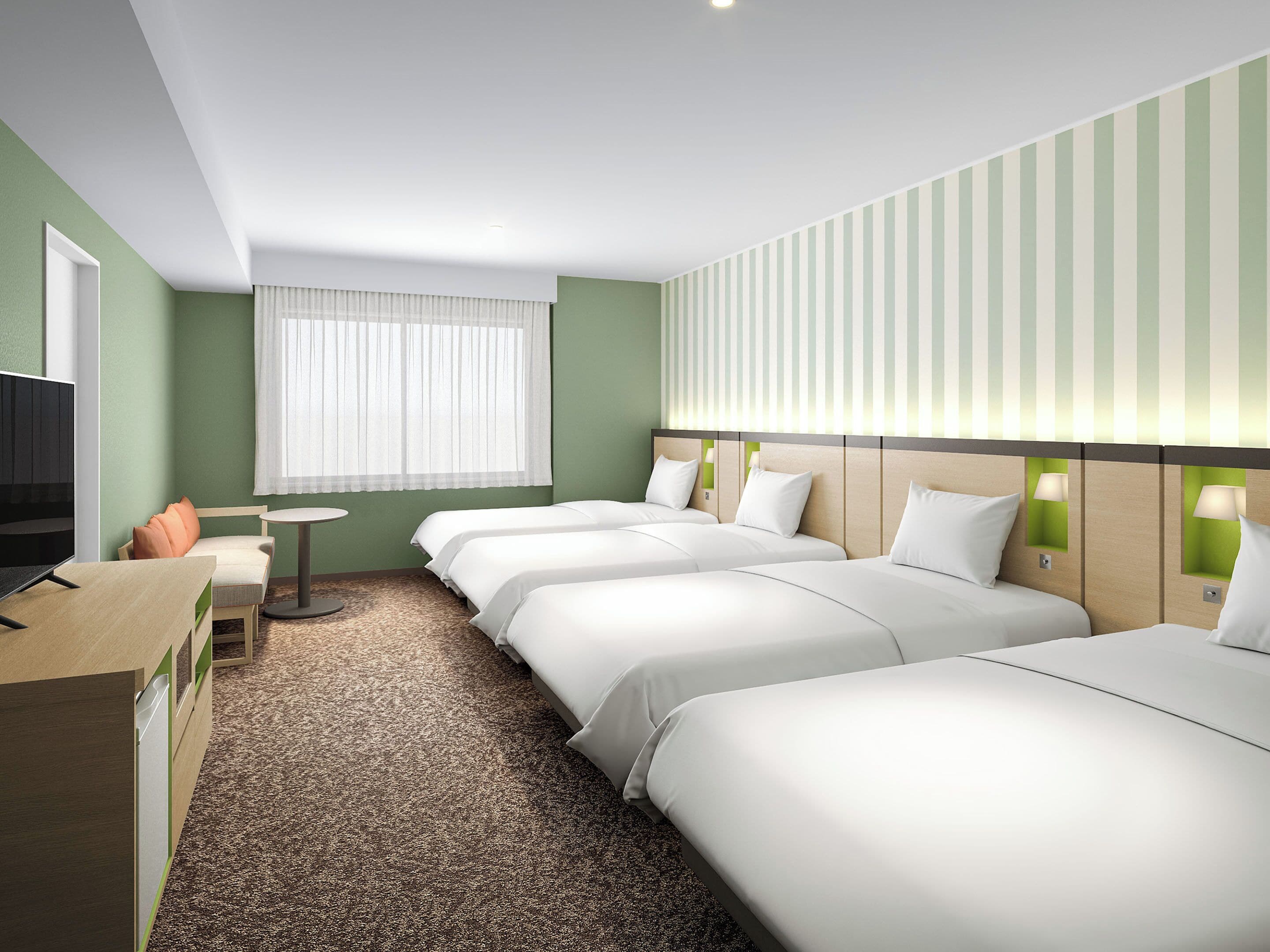A hotel room with three beds, a TV, a desk, and a window with curtains.