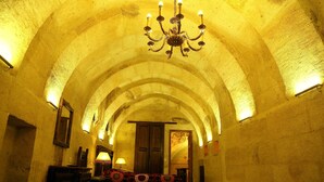 An arched hallway with a chandelier, wooden doors, and a patterned rug. - Hanımkız Konagi (Avanos)