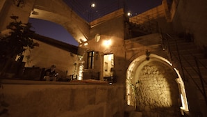 A stone building with a staircase and a balcony. - Hanımkız Konagi (Avanos)