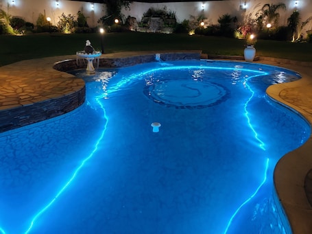 Outdoor pool, open 10:00 AM to 7:00 PM, pool umbrellas