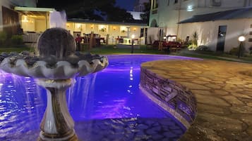 Outdoor pool, open 10:00 AM to 7:00 PM, pool umbrellas