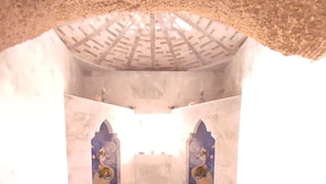 A room with a central altar, two side alcoves with statues, and a tiled floor leading to a set of stairs. - House of Cappadocia (Ürgüp)