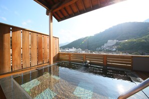 A wooden deck with a view of a city and mountains. - Ogiwarakan (Chikuma)