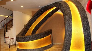 A modern reception area with a unique curved design and illuminated interior. - Nun Otel (Konya)