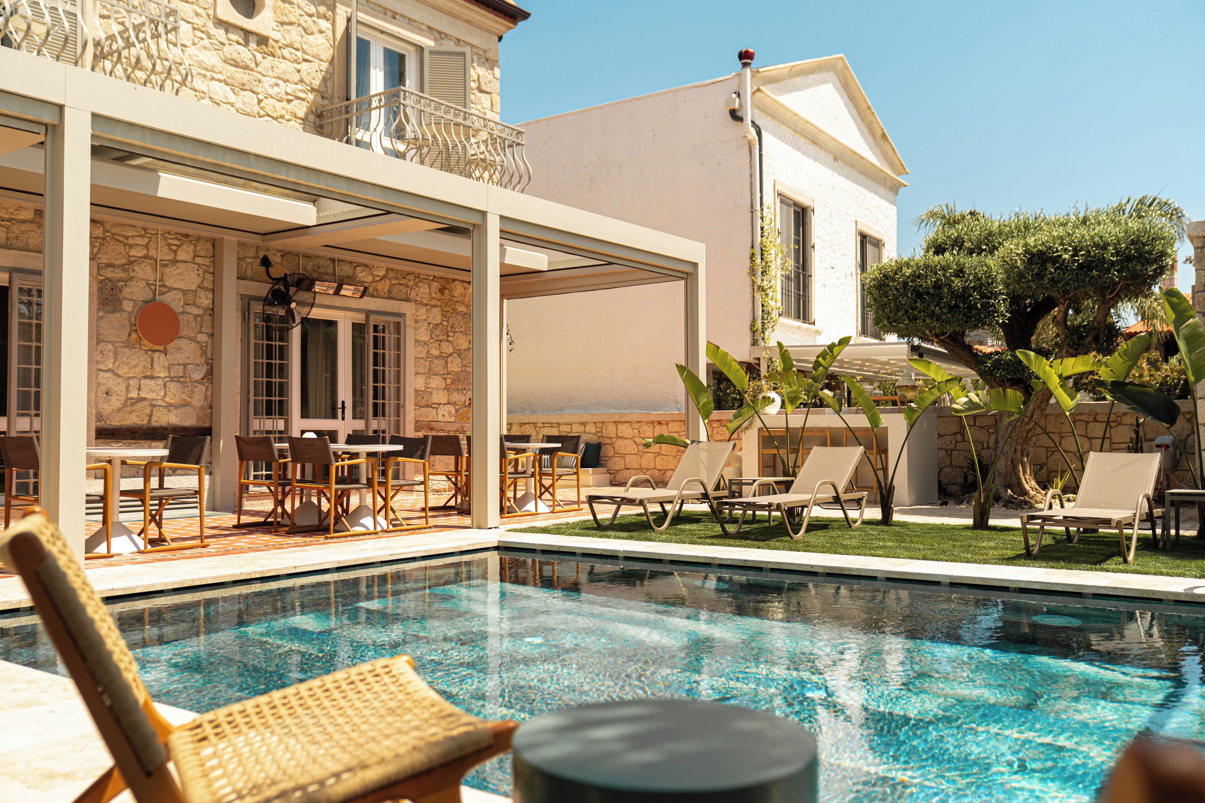 Outdoor pool, a waterfall pool, pool umbrellas, sun loungers
