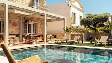 Outdoor pool, a waterfall pool, pool umbrellas, sun loungers
