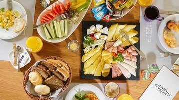 A breakfast buffet with various food items and beverages.