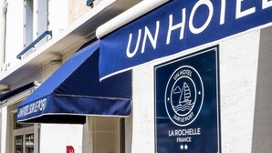 A hotel sign with "UN HOTEL" and a logo indicating "UN HOTEL SUR LE PORT LA ROCHELLE FRANCE". - Un Hôtel sur le Port (La Rochelle)