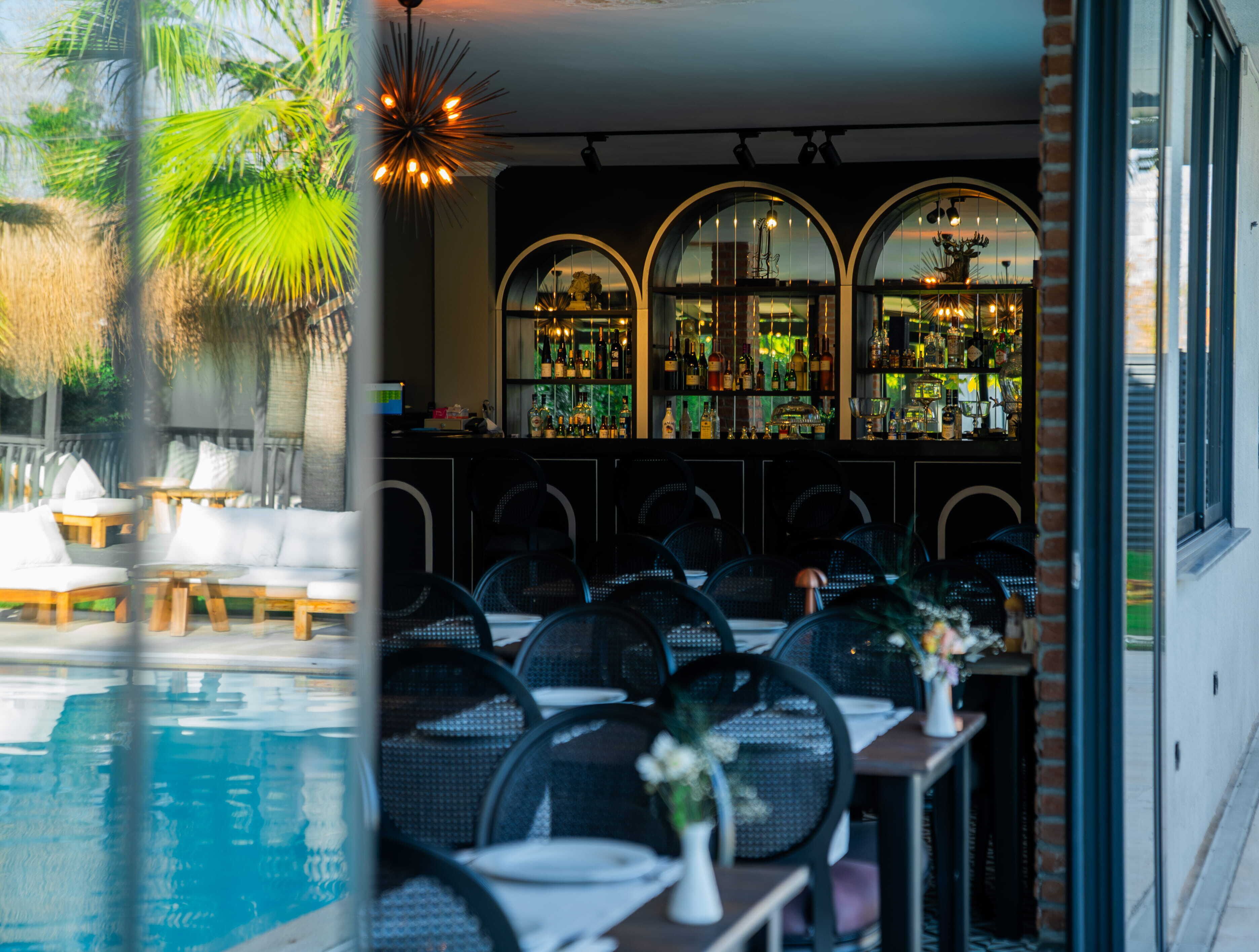 A bar area with a poolside seating arrangement.
