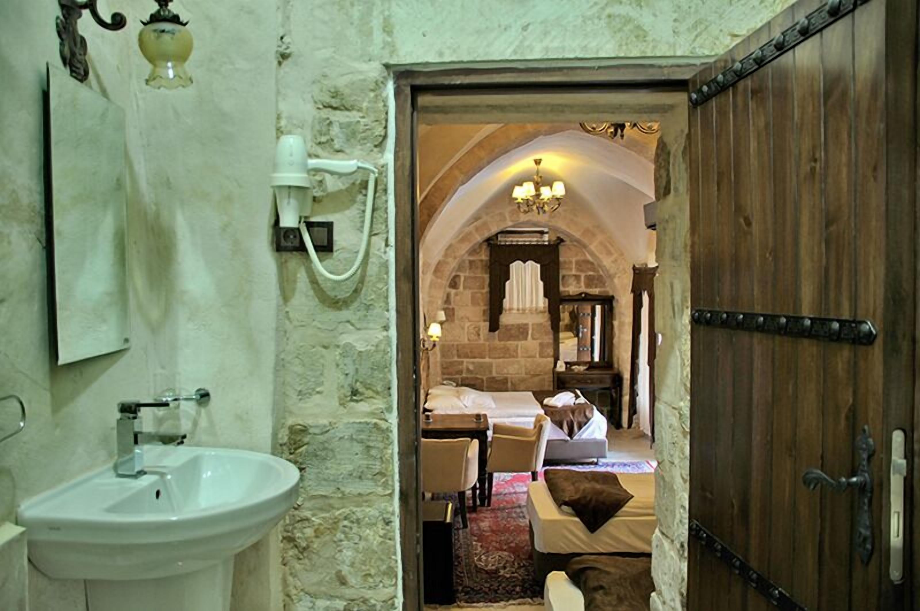 deluxe suite | bathroom | hair dryer, slippers, towels