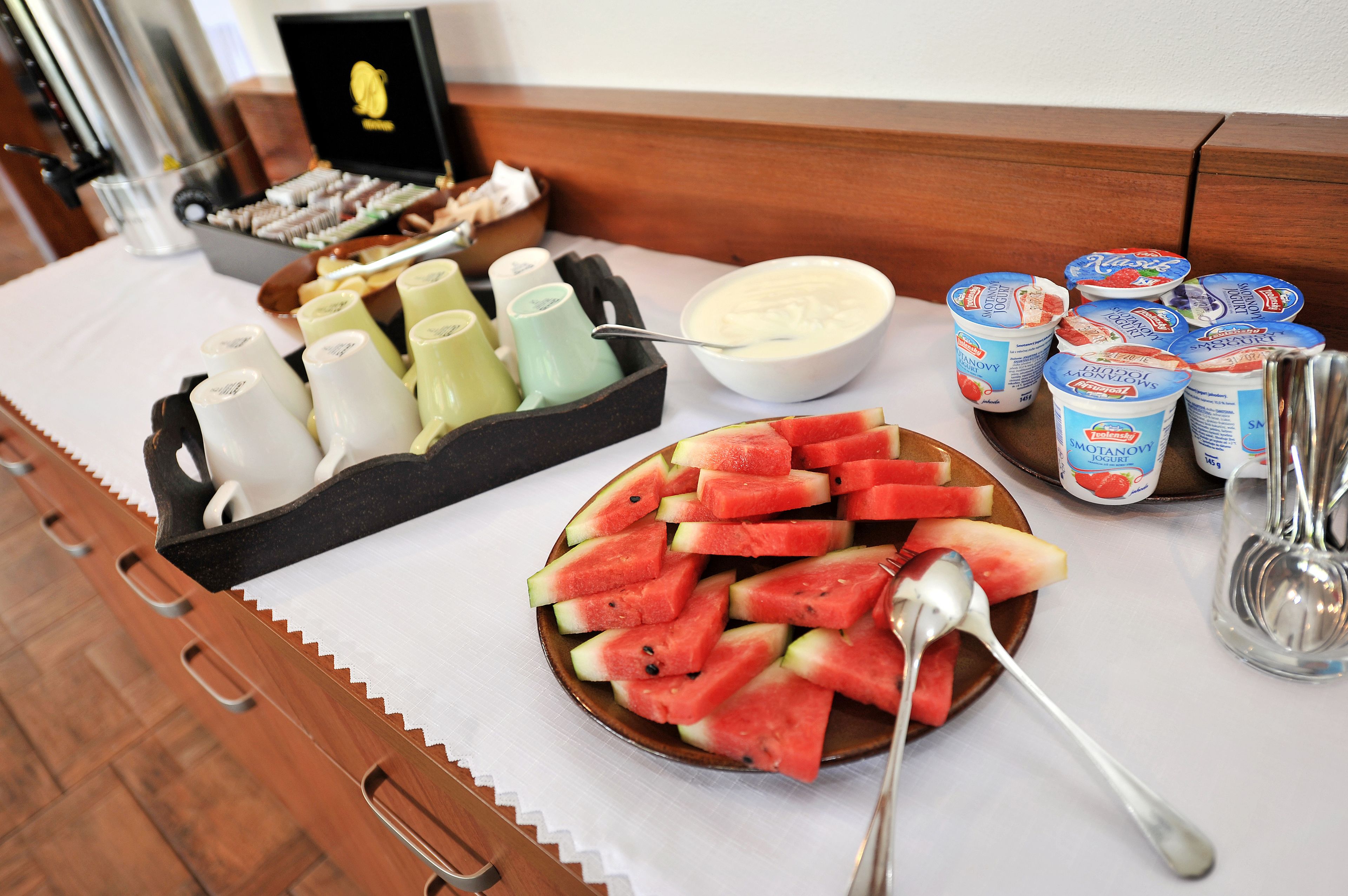 A breakfast buffet with various food items and condiments.