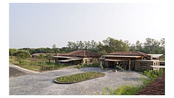 A residential area with modern houses, a paved driveway, and a landscaped garden.