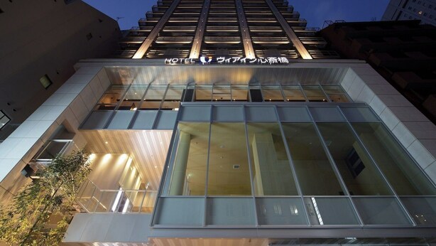 A modern hotel building with a glass facade and a sign indicating it is a hotel. - Viainn Shinsaibashi (Osaka)