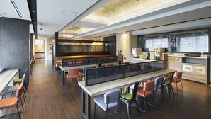 A modern restaurant with a long communal table, individual booths, and a bar area. - Viainn Shinsaibashi (Osaka)