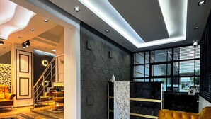 A modern living room with a marble floor, a yellow sofa, and a geometric-patterned wall. - Mersin Vip House (Mezitli)