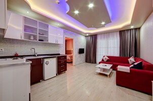 Standard Suite, 1 Bedroom, Kitchen | Living area | 32-inch LED TV with satellite channels, TV