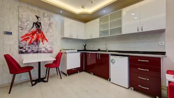 Fridge, stovetop, electric kettle, cookware/dishes/utensils